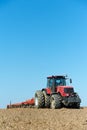 Ploughing tractor at field cultivation work