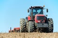 Ploughing tractor at field cultivation work