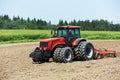 Ploughing tractor at field cultivation work