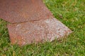 The ploughshare is rusty,close-up of an old rusty plow on the grass, a plow for plowing