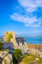 Granite house and boulder in the harbor of Pors Hir in Brittany, France