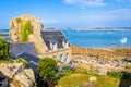 Granite house and boulder in the harbor of Pors Hir in Brittany, France