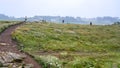 Tourists walk at green moorland in Brittany Royalty Free Stock Photo