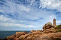 Ploumanach Mean Ruz lighthouse between the rocks in pink granite coast, Perros Guirec, Brittany, France Royalty Free Stock Photo