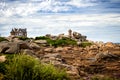 Ploumanac`h Mean Ruz lighthouse between the rocks in pink granite coast, Perros Guirec, Brittany, France. Royalty Free Stock Photo