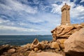 Ploumanac`h Mean Ruz lighthouse between the rocks in pink granite coast, Perros Guirec, Brittany, France. Royalty Free Stock Photo