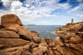 Ploumanac`h Mean Ruz lighthouse between the rocks in pink granite coast, Perros Guirec, Brittany, France. Royalty Free Stock Photo