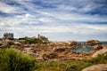 Ploumanac`h Mean Ruz lighthouse between the rocks in pink granite coast, Perros Guirec, Brittany, France. Royalty Free Stock Photo