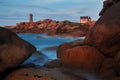 Ploumanach Mean Ruz lighthouse red sunset in pink granite coast, Perros Guirec, Brittany, France. Royalty Free Stock Photo