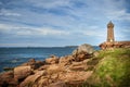 Ploumanach Mean Ruz lighthouse between the rocks in pink granite coast, Perros Guirec, Brittany, France Royalty Free Stock Photo