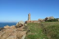 Ploumanach Mean Ruz lighthouse on the rocky seashore of pink granite coast in France Royalty Free Stock Photo