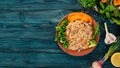 Plov Rice with meat and vegetables on a plate. Uzbek cuisine. On a wooden background. Top view.