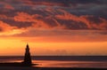 Plover Scar lighthouse with fiery clouds sunset