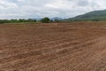 Plow field prepared for planting crops in spring - plowed field with truck in agricultural farm countryside Royalty Free Stock Photo