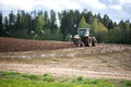 Plow tractor surrounded by birds seagulls and storks Royalty Free Stock Photo