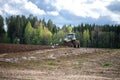 Plow tractor surrounded by birds seagulls and storks Royalty Free Stock Photo