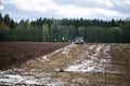 Plow tractor surrounded by birds seagulls and storks Royalty Free Stock Photo