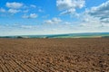 A plowed agricultural field against a blue sky Royalty Free Stock Photo