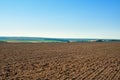 A plowed agricultural field against a blue sky Royalty Free Stock Photo
