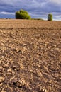 Plowed autumn farm field landscape with clouds Royalty Free Stock Photo