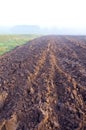 Plowed autumn farm field and mist Royalty Free Stock Photo