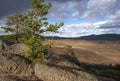 Plowed field, arable land, among the rocks, blue sky with clouds, landscape Royalty Free Stock Photo