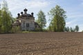 Plowed field on a background of crumbling church. Concept of rebirth of life