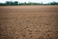 Plowed field and blue sky, soil and clouds of a bright sunny day - concept of agriculture Royalty Free Stock Photo