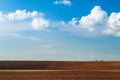 plowed field and blue sky in sunset. Royalty Free Stock Photo