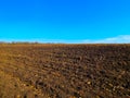 Plowed field in early spring, with blue sky Royalty Free Stock Photo