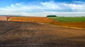 plowed field and soybean brown field in autumn and winter cereals in the distance, patchwork and field lines