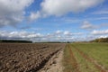 Plowed field and uncultivated land nearby. Agriculture Royalty Free Stock Photo