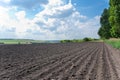 Plowed field under cloudy sky Royalty Free Stock Photo