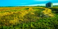 Plowed hay field and silos Royalty Free Stock Photo