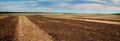 Plowed land, groves and hills in the background of rural lands