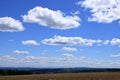 Plowed or Ploughed Field in Countryside and Blue Sky with Clouds over Horizon Royalty Free Stock Photo