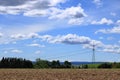 Plowed or Ploughed Field in Countryside and Blue Sky with Clouds over Horizon Royalty Free Stock Photo