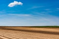 Plowed or Ploughed Fields in Countryside. Organic Food and Agriculture. Blue Sky over Horizon