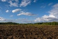 Arable land on a sunny evening under a beautiful cloudy sky. Royalty Free Stock Photo