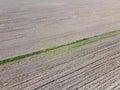 Plowed soil, aerial view, landscape. Lots of traces from vehicles on the ground