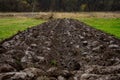 Plowing the land for growing cultivated plants  autumn plowing in the villages. Bed in the area with plowed arable land Royalty Free Stock Photo