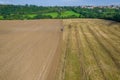 Plowing the land with a tractor, aerial view.