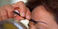 Plucking eyebrows Royalty Free Stock Photo