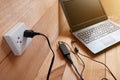 Plug in Adapter power cord charger of laptop computer On wooden Royalty Free Stock Photo