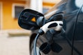 Plug-in hybrid EV car charging at charge station, home