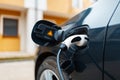 Plug-in hybrid EV concept, car charging at charge station, home Royalty Free Stock Photo