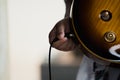 Plug jack cable in electric guitar,Hand inserts input jack to electric guitar Royalty Free Stock Photo