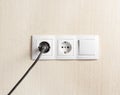 the plug is plugged into an electrical outlet on the wall Royalty Free Stock Photo