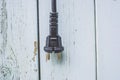 Plug from a power socket on a wooden background Royalty Free Stock Photo