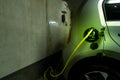 A plugged in electric type 2 wire at the charging socket of an electric car with the Wallbox, the home charging station